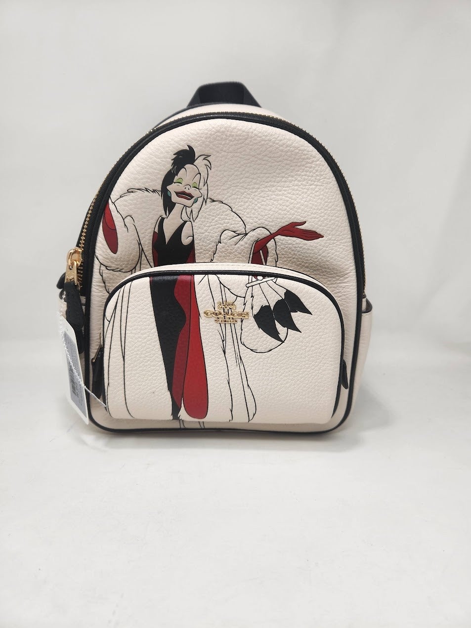 coach cruella backpack Disney X Coach Mini Court With Motif Refined pebble leather Inside zip and multifunction pockets Double zip closure fabric lining Handle with 1 1/2 drop Outside zip and open pockets Adjustable shoulder straps 7 3/4 (L) x 8 3/4 (H) x 3 1/2 (W) Part of a special collaboration where Disneys most iconic villains meet iconic Coach design Disney x Coach Disney Style No. COACH Disney Cruella Motif Mini